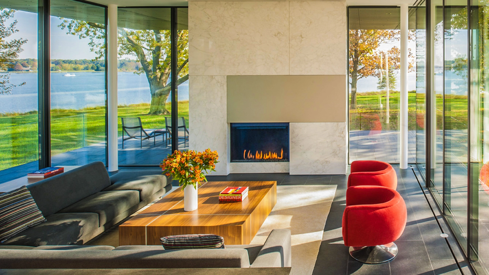 Modern lakefront living room with fireplace