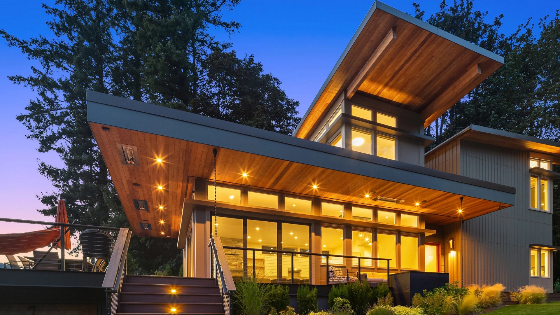 Contemporary architectural home illuminated at twilight