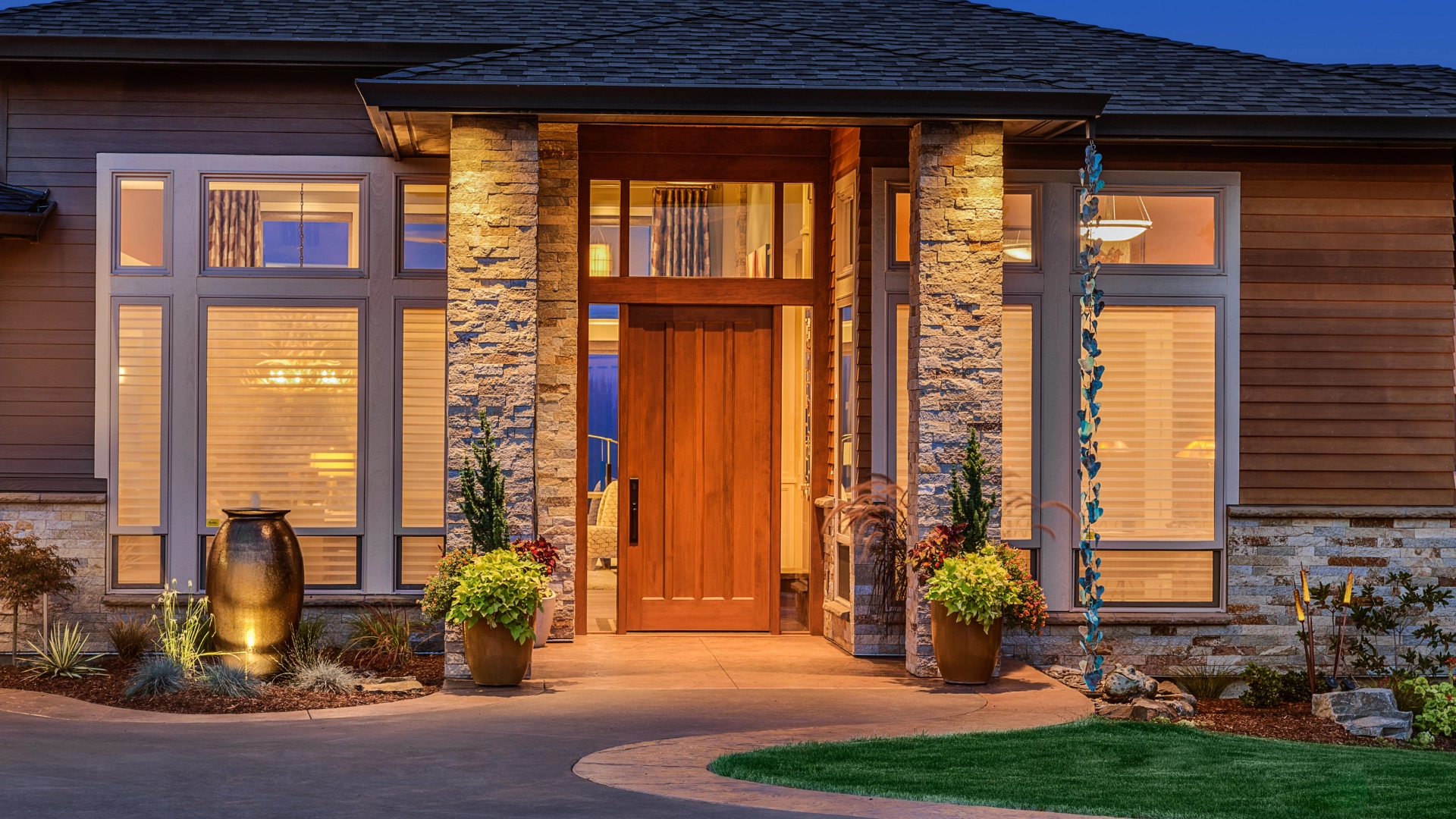 Warmly lit stone and wood home entrance at dusk